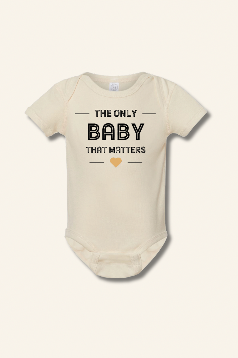Beige baby onesie with text 'The Only Baby That Matters' on a white background