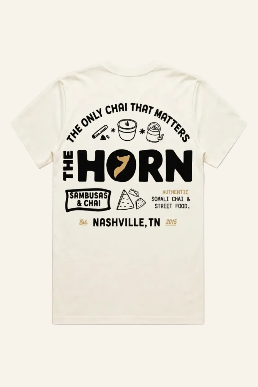 Beige t-shirt with black text and graphics on a white background