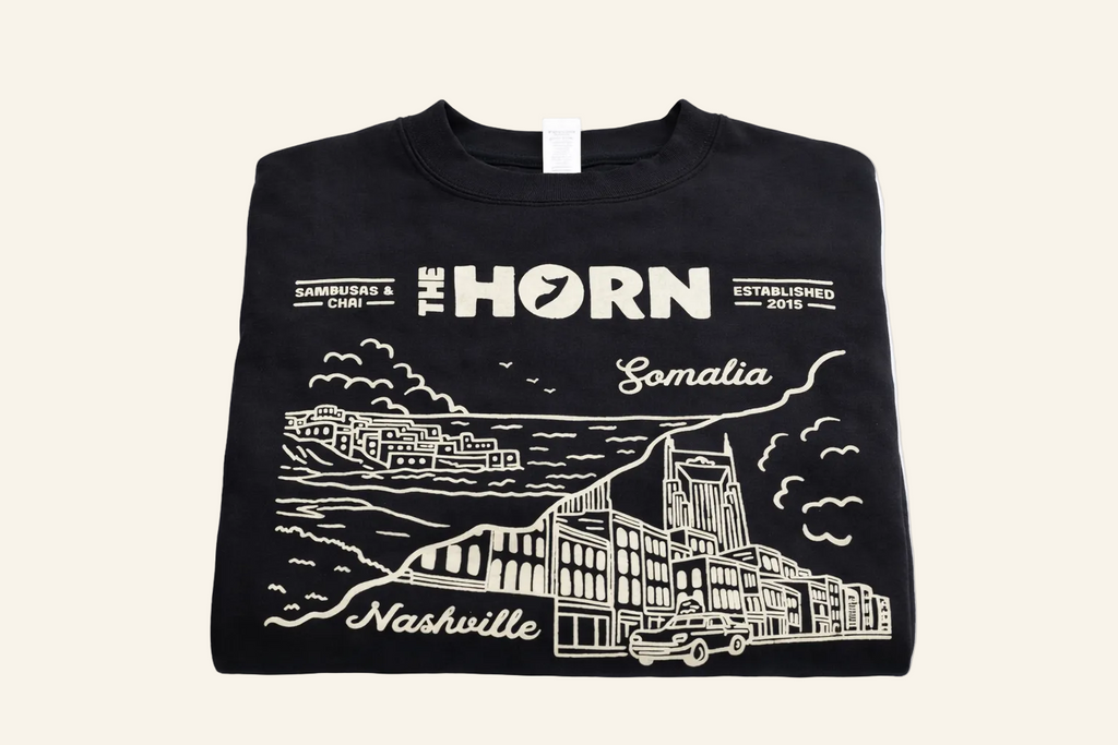 Black sweatshirt with white graphics and text on a white background