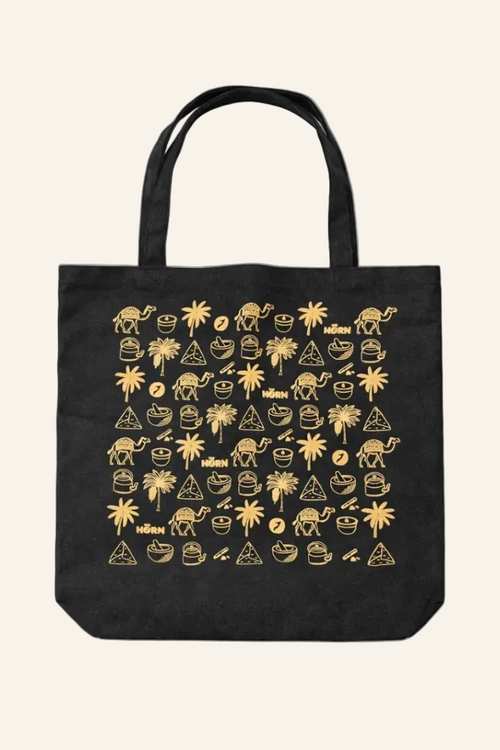 Black tote bag with gold graphic design on a white background