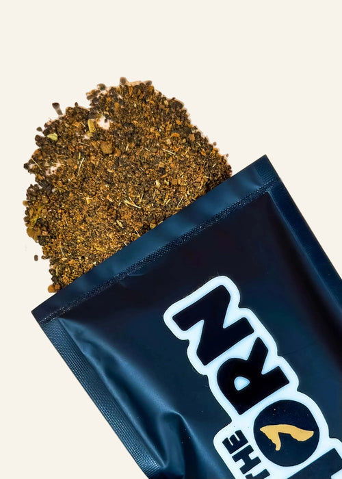Open packaging with 'The Horn' loose leaf chai sample on a beige background.