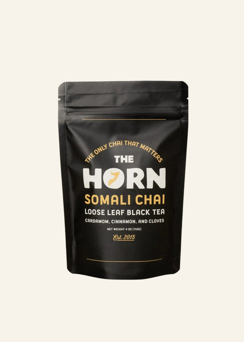 Loose leaf tea and spices package labeled 'The Horn Somali Chai' on a beige background